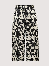Plus size abstract print wide-leg pants in black and white geometric pattern with drawstring waistband