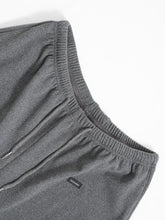 Gray heathered cotton relaxed fit drawstring pants with ribbed elastic waistband and small black fashion label