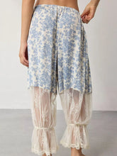 Blue and white floral lace patchwork wide-leg pants featuring sheer lace overlay at the hem in floral lace design