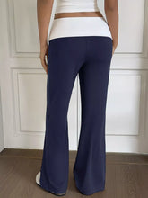 Navy blue wide leg pants with a white waistband made from soft fabric for stylish and comfortable wear