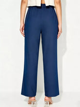 Navy blue tailored tied wide leg pants featuring high waist and subtle pleats for a sleek fit