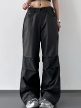 Black wide leg cargo pants with structured utilitarian design and subtle paneling in a durable fabric
