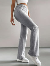 Gray ribbed knit high waist flare pants featuring a ribbed knit texture and a flared high-rise design