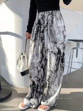 Black and white marble-patterned abstract print wide leg pants with a flowy silhouette and comfortable fit