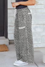 Black and white animal print wide leg terry knit pants with a drawstring waistband for comfortable wear