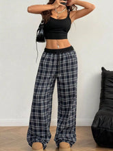 Black and white plaid pants with a relaxed fit and elastic waistband for comfortable everyday wear