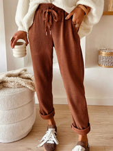 Casual corduroy drawstring waist pants in warm brown with vertical ribbed texture and adjustable drawstring waist