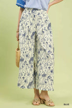 Cream-colored umgee two tone floral print pants featuring wide-leg design and delicate blue floral pattern