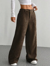 Brown corduroy wide leg pants with relaxed fit front pockets and corduroy texture perfect for ankle boots