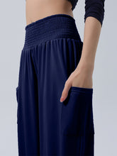 Navy blue full size smocked waist harem pants with wide-leg fit and side pockets plus size design