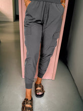 Gray elastic high waist pocketed cargo jogger pants with side pockets paired with leopard print sandals