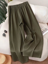 Olive green satin wide-leg button-accent pants with elastic waistband featuring a flowy silhouette and smooth finish