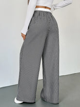 Black and white striped wide leg drawstring pants with elastic waistband for comfortable casual wear