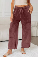 Mauve velvet wash wide leg pants with elastic waistband and drawstring featuring wide leg design and care instructions