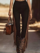 Brown leather handbag with fringed detailing complements fringe trim high waist pants for stylish casual wear