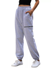 Light gray heathered casual high waist cutout joggers with elastic waistband and black zipper pocket accents