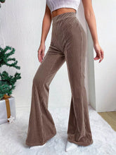 Brown corduroy high waist flare pants featuring a vertical ribbed texture and a flattering high waist fit