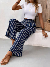 Navy blue and white striped wide leg pants made of lightweight fabric with care instructions for easy maintenance