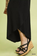 Black strappy wedge sandals with cork sole paired with umgee flowy asymmetrical hem wide leg pants