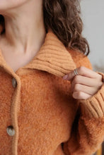 Orange fuzzy long sleeve cardigan with collared neck button front