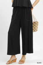 Black linen frayed side pocket wide leg pants with white stitching and decorative beaded trim along the side seam