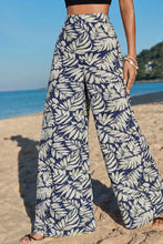 High-waisted wide-leg pants in navy blue and cream leaf print fabric featuring a stylish leaf print wide design