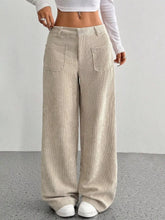 Beige corduroy wide leg pants with ribbed texture and front pockets perfect for styling with ankle boots
