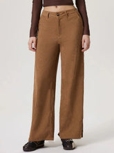 Brown corduroy wide leg pants with straight cut button closure and functional pockets for casual wear