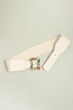 White elastic belt with multicolored leaf buckle and gemstone detailing
