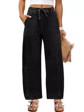 Black wide leg jeans made of denim with an elastic waistband and drawstring for comfortable wear