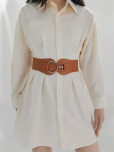 Elastic wide belt with gold O-ring buckle on cream shirt dress