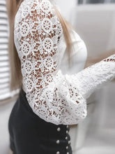 White lace long sleeve top with elegant floral patterns and puffed cuffs perfect for a stylish satin blouse look