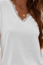 Elegant lace v-neck t-shirt with delicate trim and gold necklaces