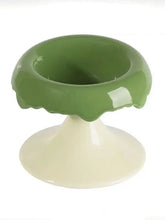 Elevated ceramic pet bowl with green glossy scalloped rim