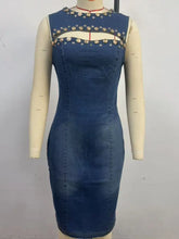 Navy blue sleeveless denim dress with fitted silhouette and gold-toned studs embellishing cutout neckline