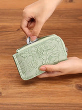 Delicate mint green embossed floral leather bifold wallet with silver zipper