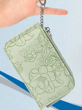Mint green floral embossed bifold wallet with silver zipper and chain keyring