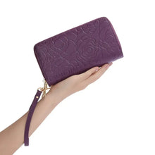 Purple floral embossed leather wallet with gold zipper and strap