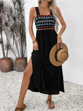 Black embroidered maxi dress with colorful bodice and woven straw hat