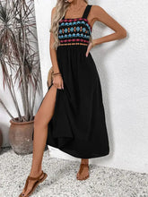 Embroidered black maxi dress with colorful floral bodice and high slit