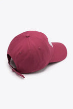 Maroon embroidered graphic baseball cap with white emblem and adjustable strap
