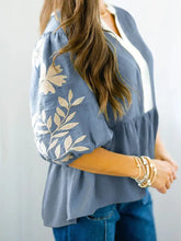 Blue peplum blouse with cream leaf embroidery on sleeves and white contrast panel down the front sleeve peplum blouse