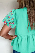 A vibrant mint green embroidered sleeve textured blouse with colorful floral embroidery on short puffed sleeves