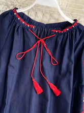 Navy blue embroidered tassel tie neck blouse with red trim and matching tassels at the neckline