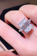 Elegant sterling silver ring with emerald cut carat moissanite and triangular side stones