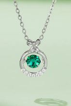 Elegant emerald pendant necklace with sterling silver chain and bow detail