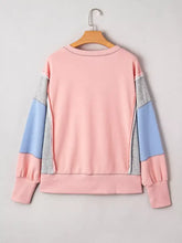 Pastel pink light blue and heather gray color block patchwork sweatshirt with exposed seams and elastic slit cuffs