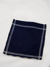 A navy blue color block patch pocket sweatshirt with exposed zigzag seam detail and machine wash cold care instructions