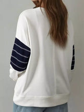 White sweatshirt with navy blue striped sleeves and exposed seam detail machine wash cold recommended