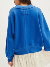A vibrant royal blue oversized exposed seam sweatshirt with dropped shoulder and quilted patch at the back, machine wash cold